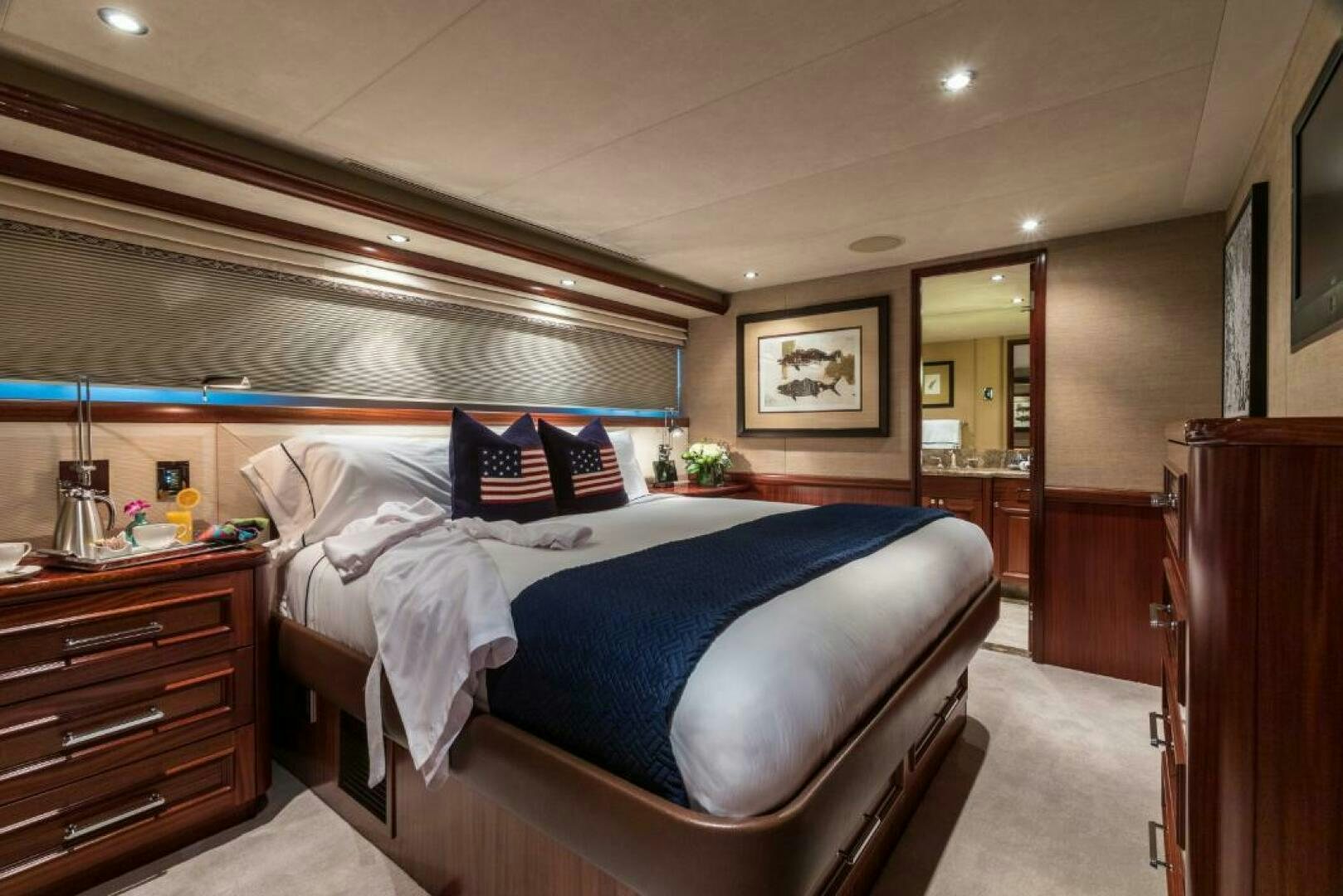 a bedroom with a bed and a dresser aboard TRUST FUN Yacht for Sale