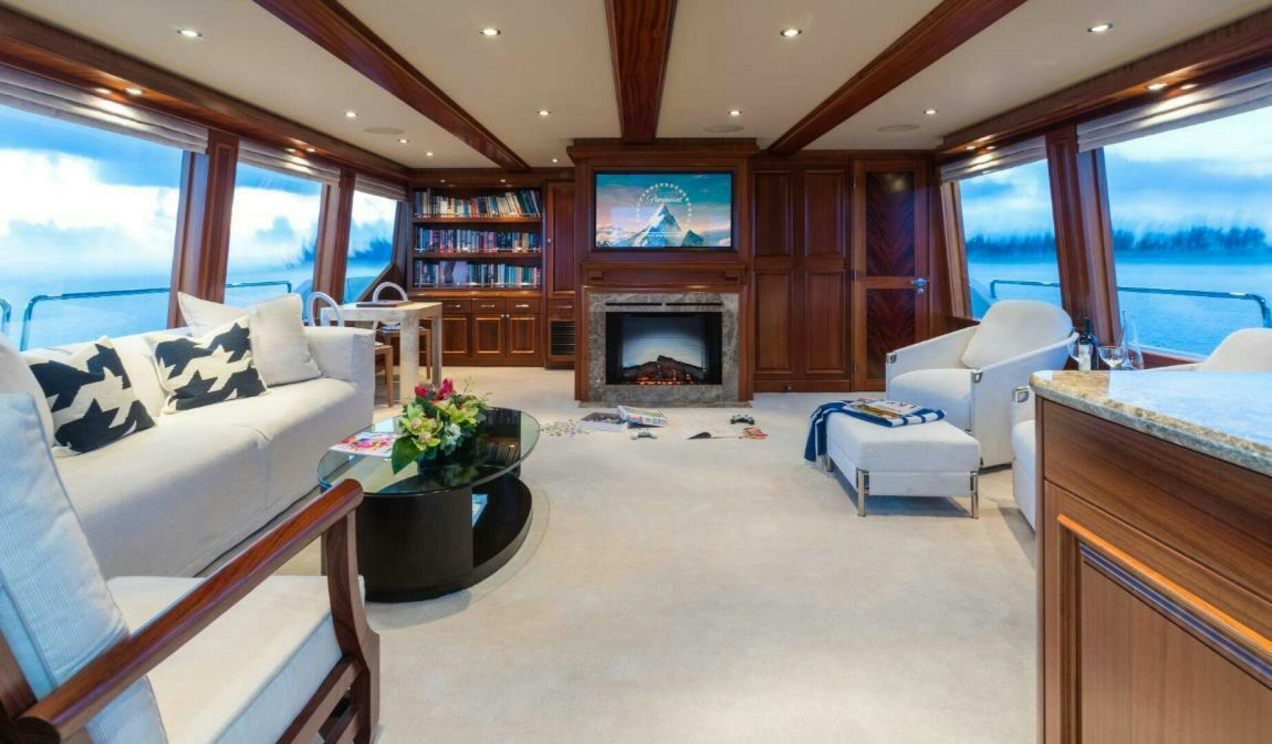 a living room with a fireplace aboard TRUST FUN Yacht for Sale