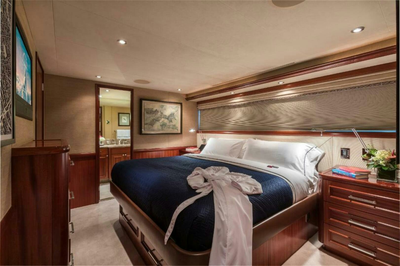 a bedroom with a bed and a television aboard TRUST FUN Yacht for Sale