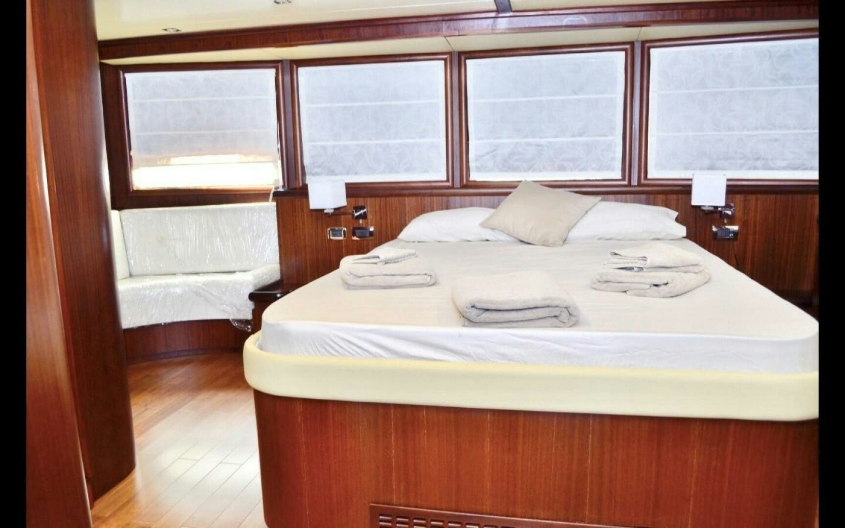 a bed with white sheets aboard MARILOAN FELNIC II Yacht for Sale