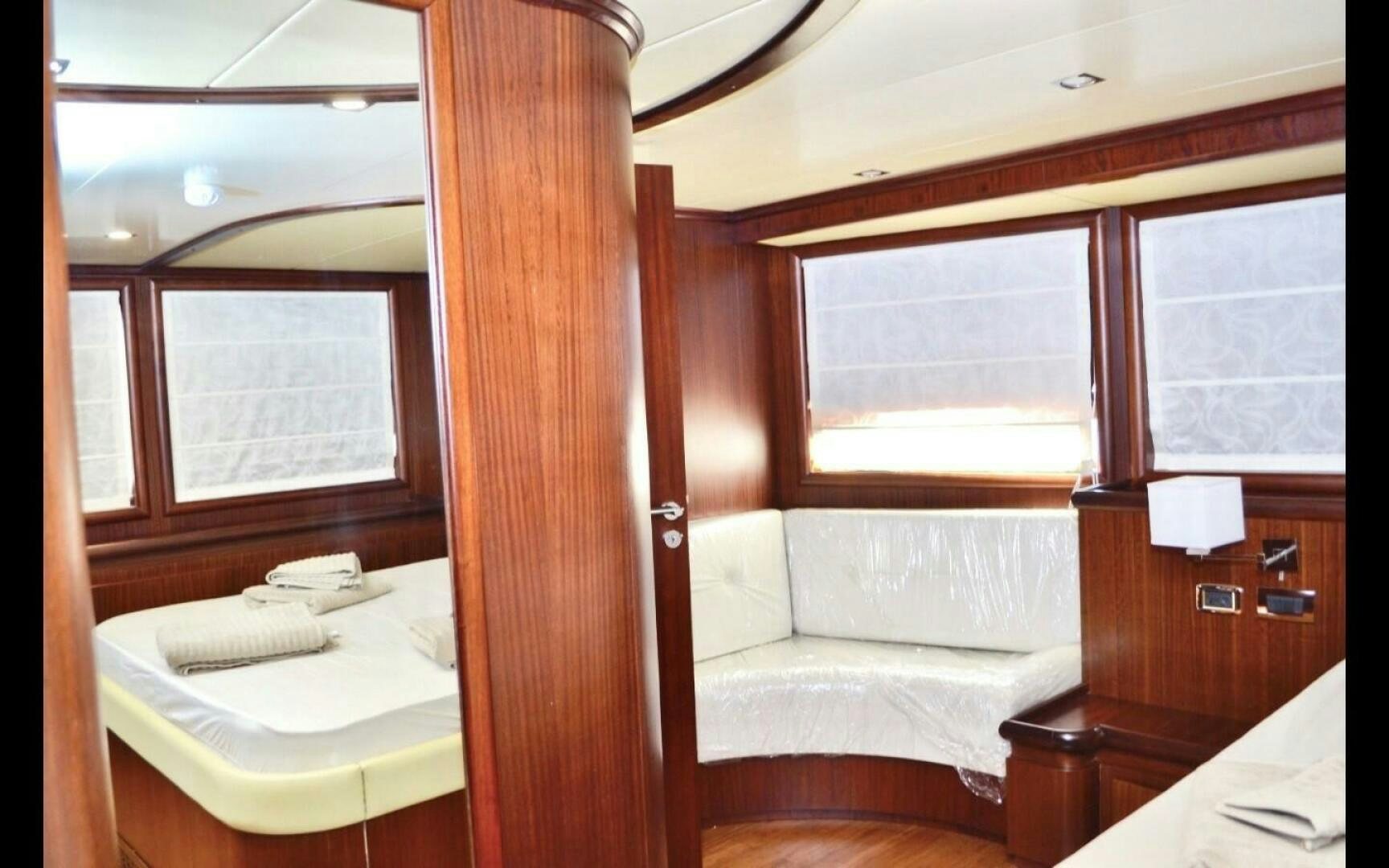 a room with a bed and a window aboard MARILOAN FELNIC II Yacht for Sale