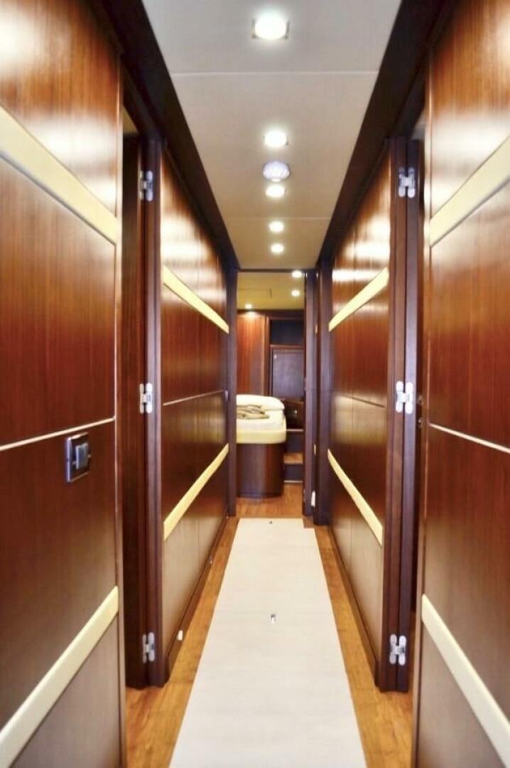 a hallway with a door and a bed in it aboard MARILOAN FELNIC II Yacht for Sale