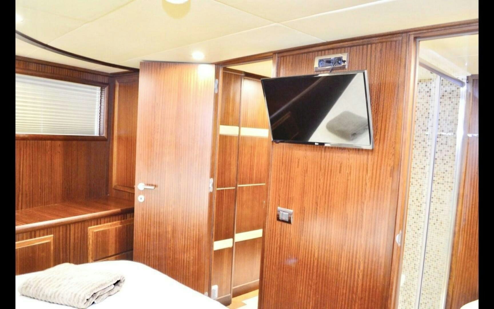 a bedroom with a mirror aboard MARILOAN FELNIC II Yacht for Sale