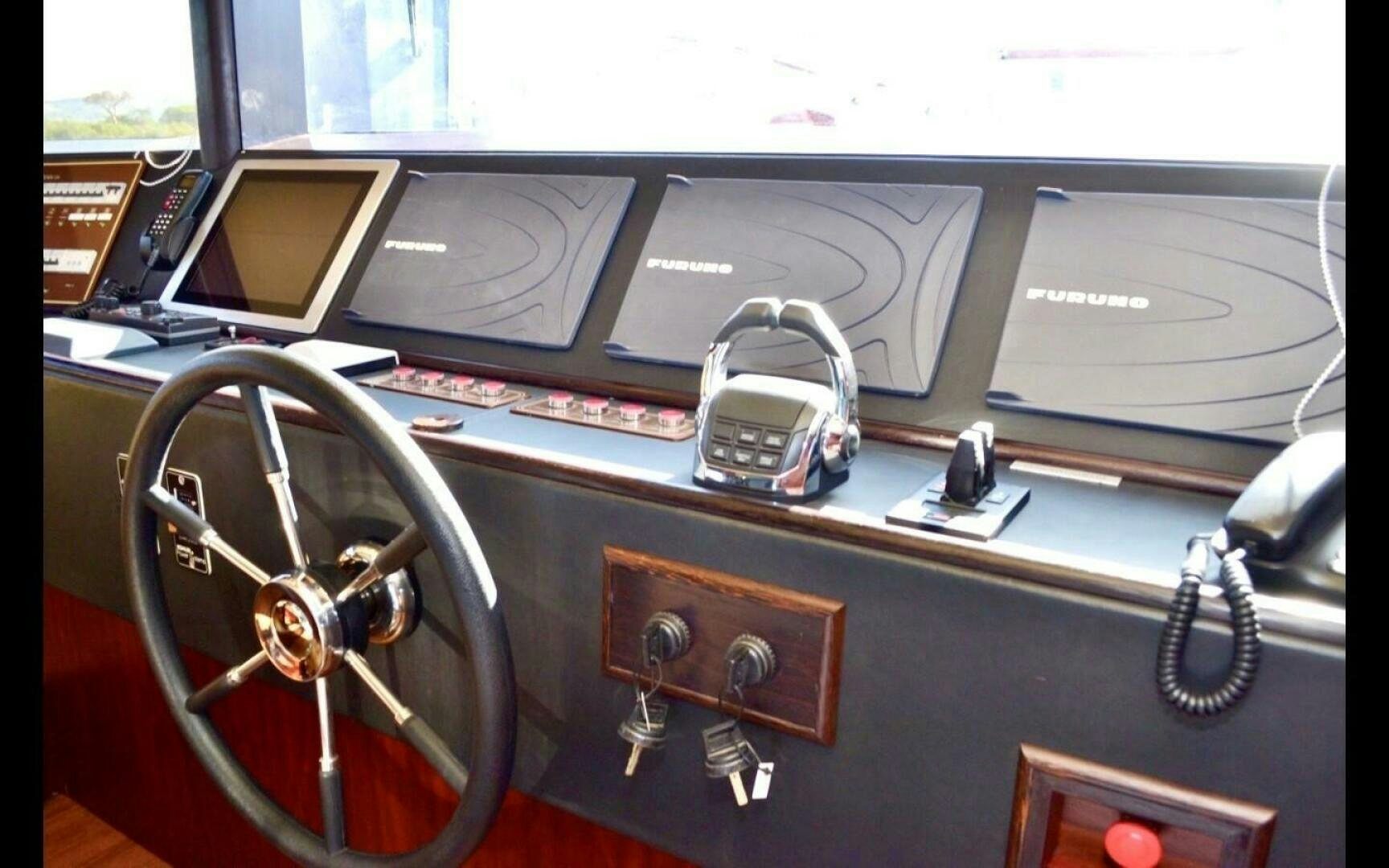 a car with a steering wheel and laptops on the side aboard MARILOAN FELNIC II Yacht for Sale