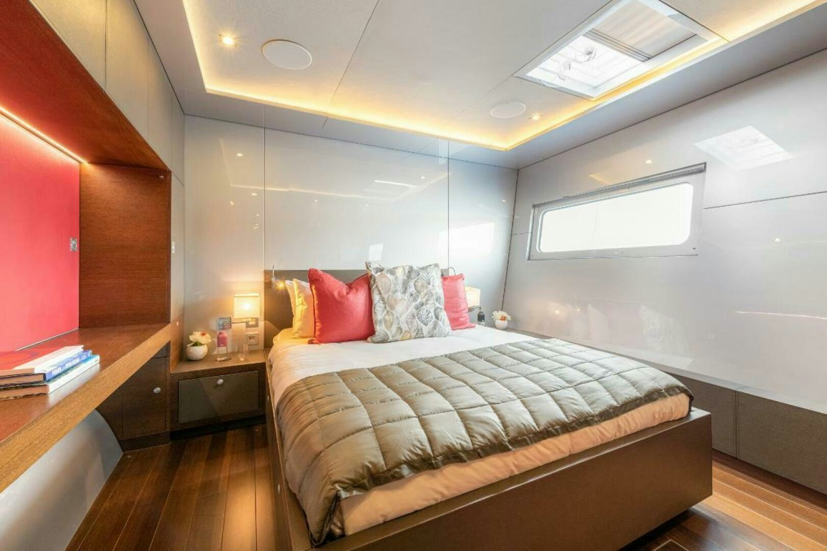a bedroom with a bed and a desk aboard MOUSETRAP Yacht for Sale
