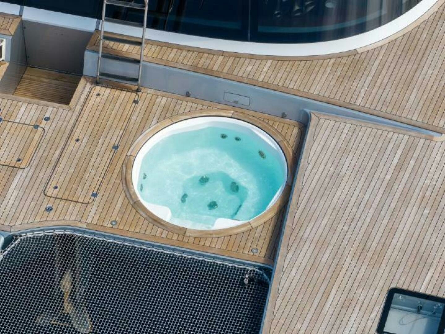 a white bowl on a wooden surface aboard MOUSETRAP Yacht for Sale