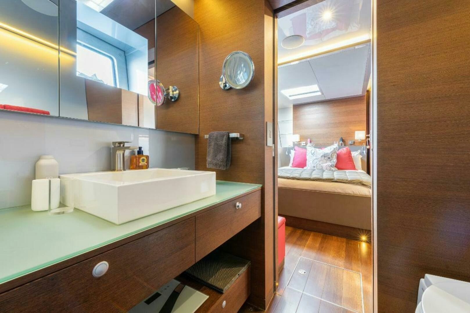 a bathroom with a sink and a bed aboard MOUSETRAP Yacht for Sale