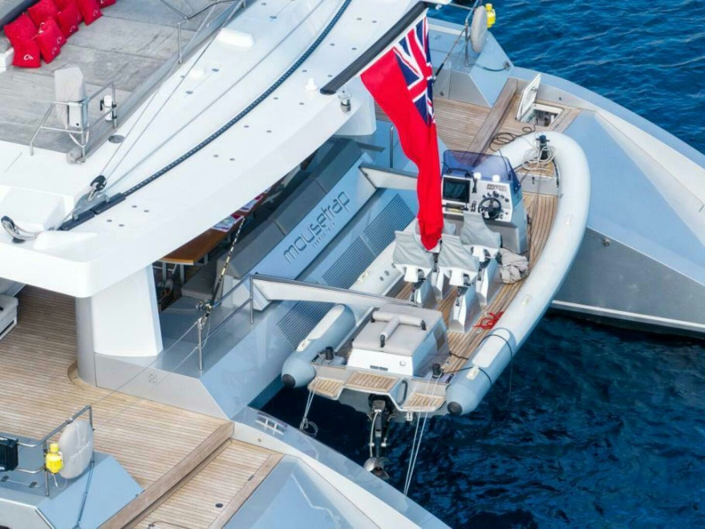 a boat with a red flag aboard MOUSETRAP Yacht for Sale
