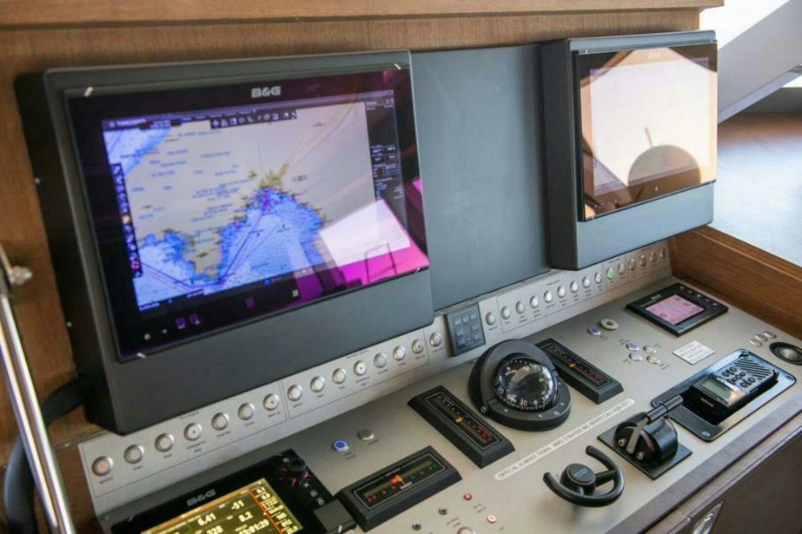 a computer monitor with a keyboard and a mouse on a desk aboard MOUSETRAP Yacht for Sale