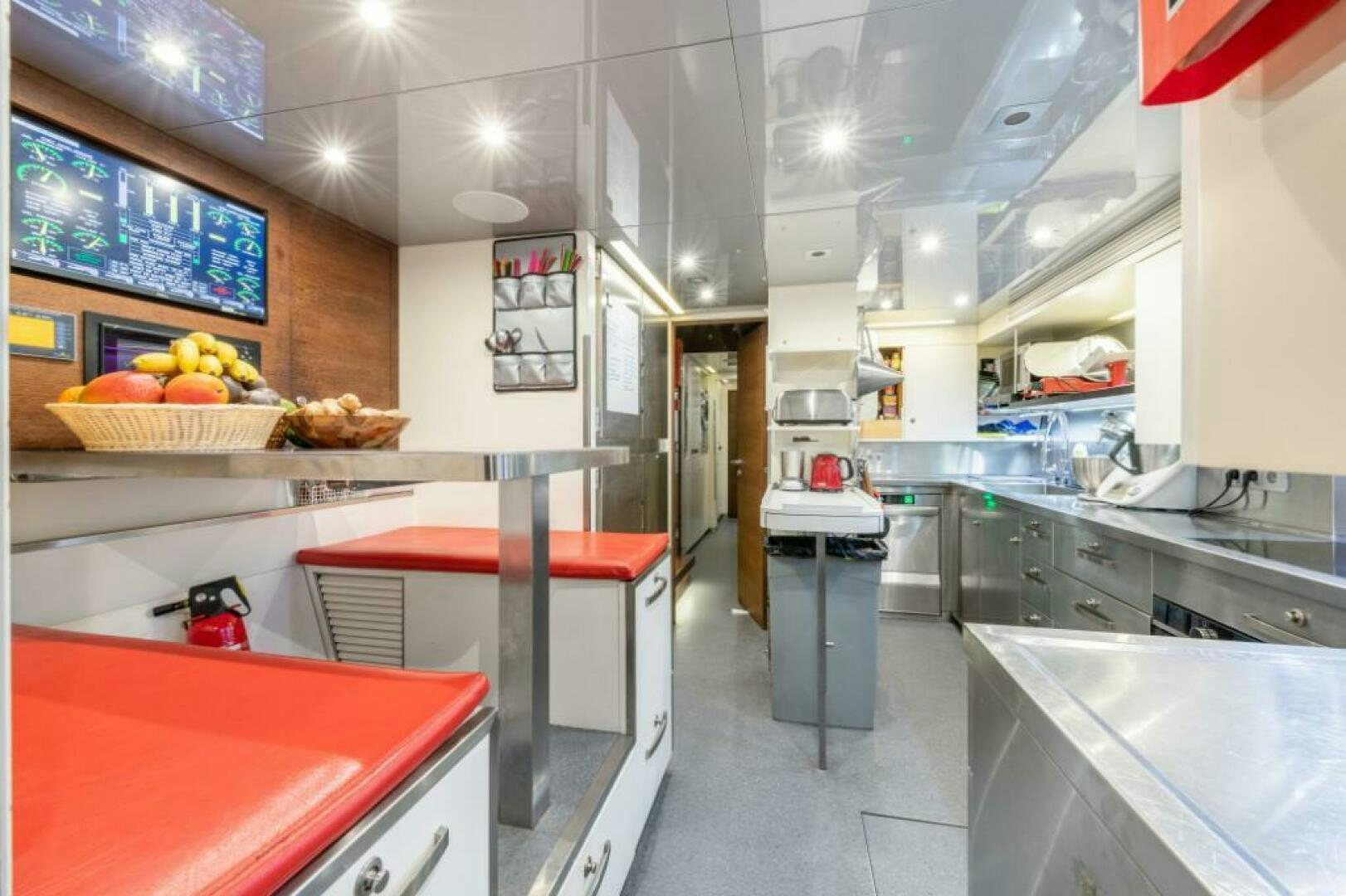 a kitchen with a red counter and cabinets aboard MOUSETRAP Yacht for Sale