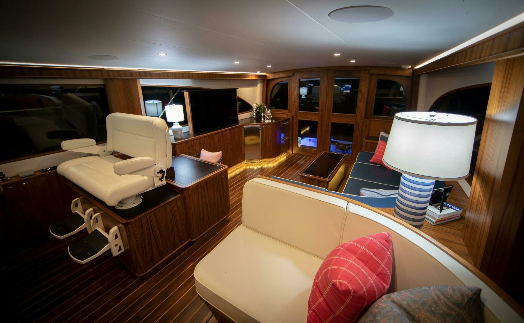 a living room with a couch and a lamp aboard PRIVATEER Yacht for Sale