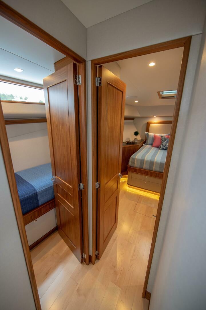 a room with a bed and a closet aboard PRIVATEER Yacht for Sale