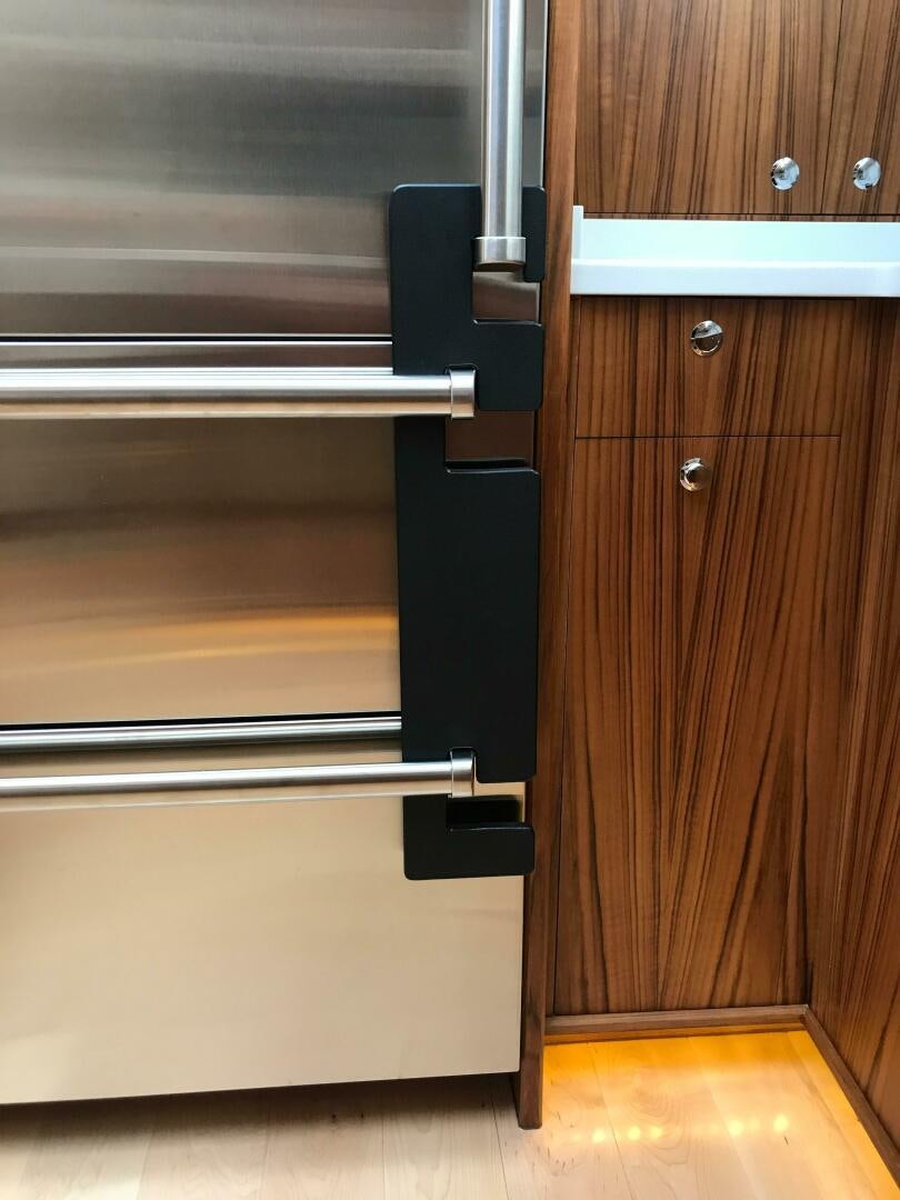 a kitchen with a steel door aboard PRIVATEER Yacht for Sale