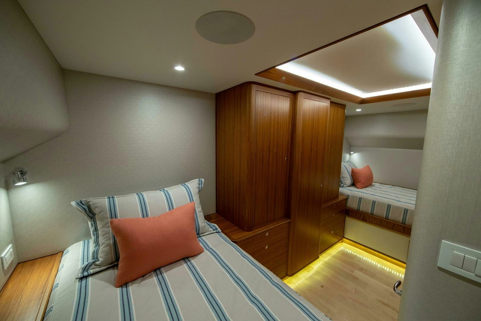 a room with a bed and a chair aboard PRIVATEER Yacht for Sale