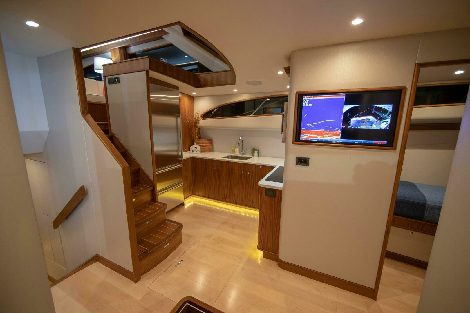 a room with a tv and a wood floor aboard PRIVATEER Yacht for Sale