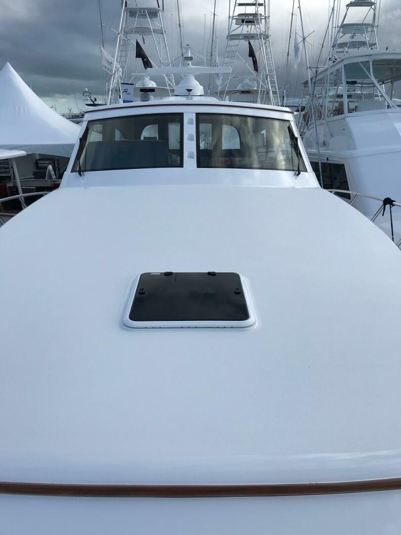 a white yacht with a black seat aboard PRIVATEER Yacht for Sale