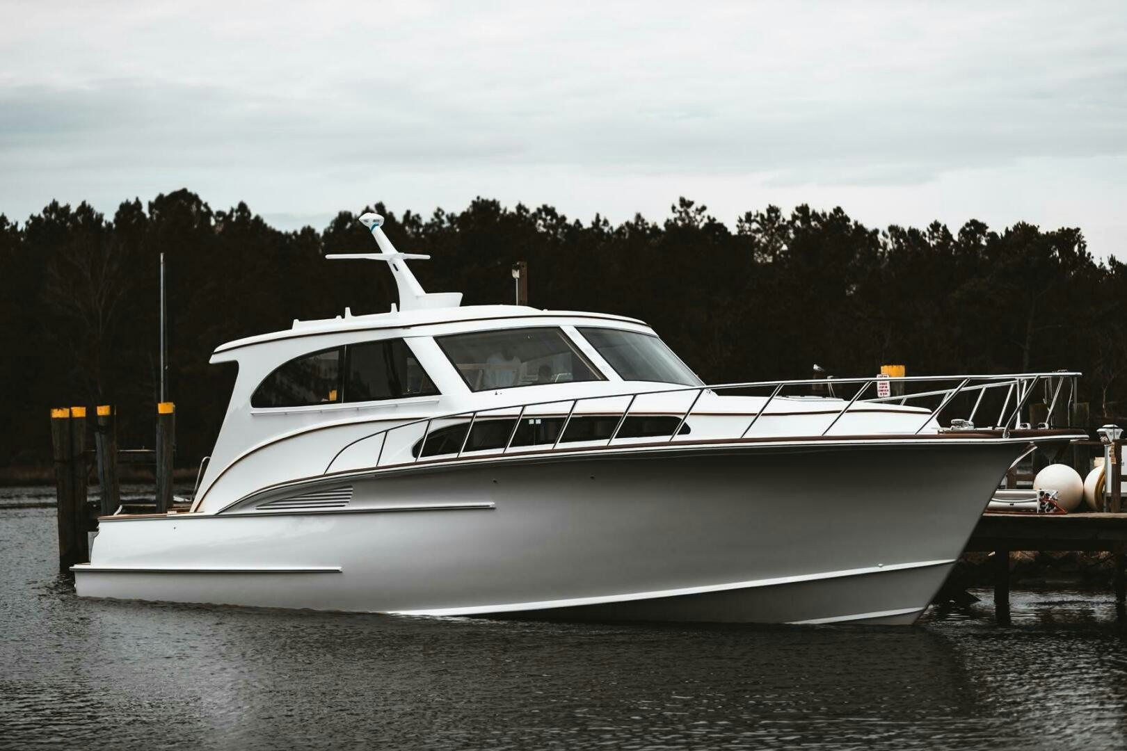 a white yacht on a dock aboard PRIVATEER Yacht for Sale