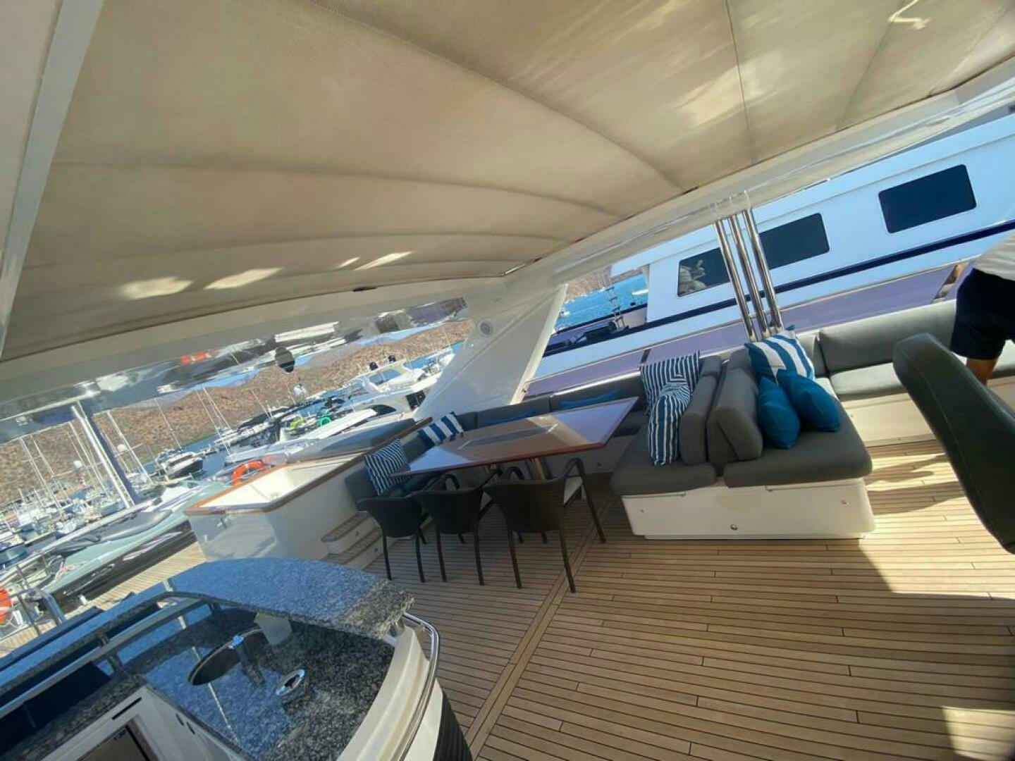 a room with a wood floor and a couch and a table with chairs aboard PRINCESS TWO Yacht for Sale