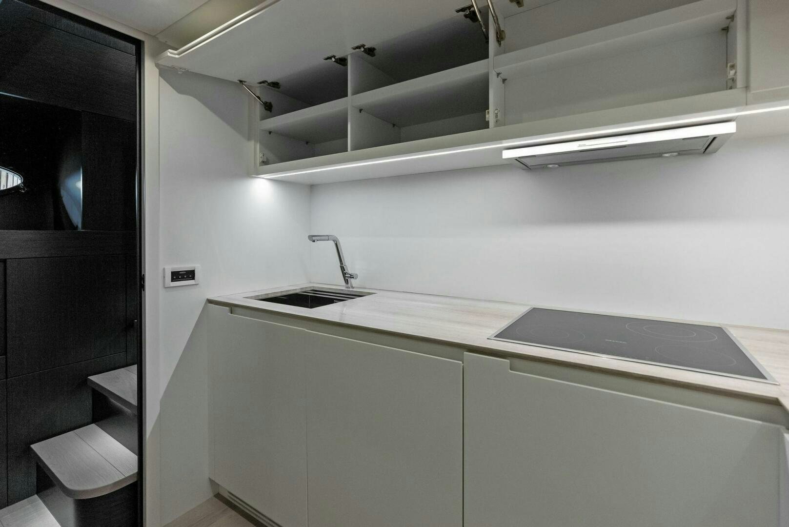 a kitchen with white cabinets aboard OUR TRADE Yacht for Sale