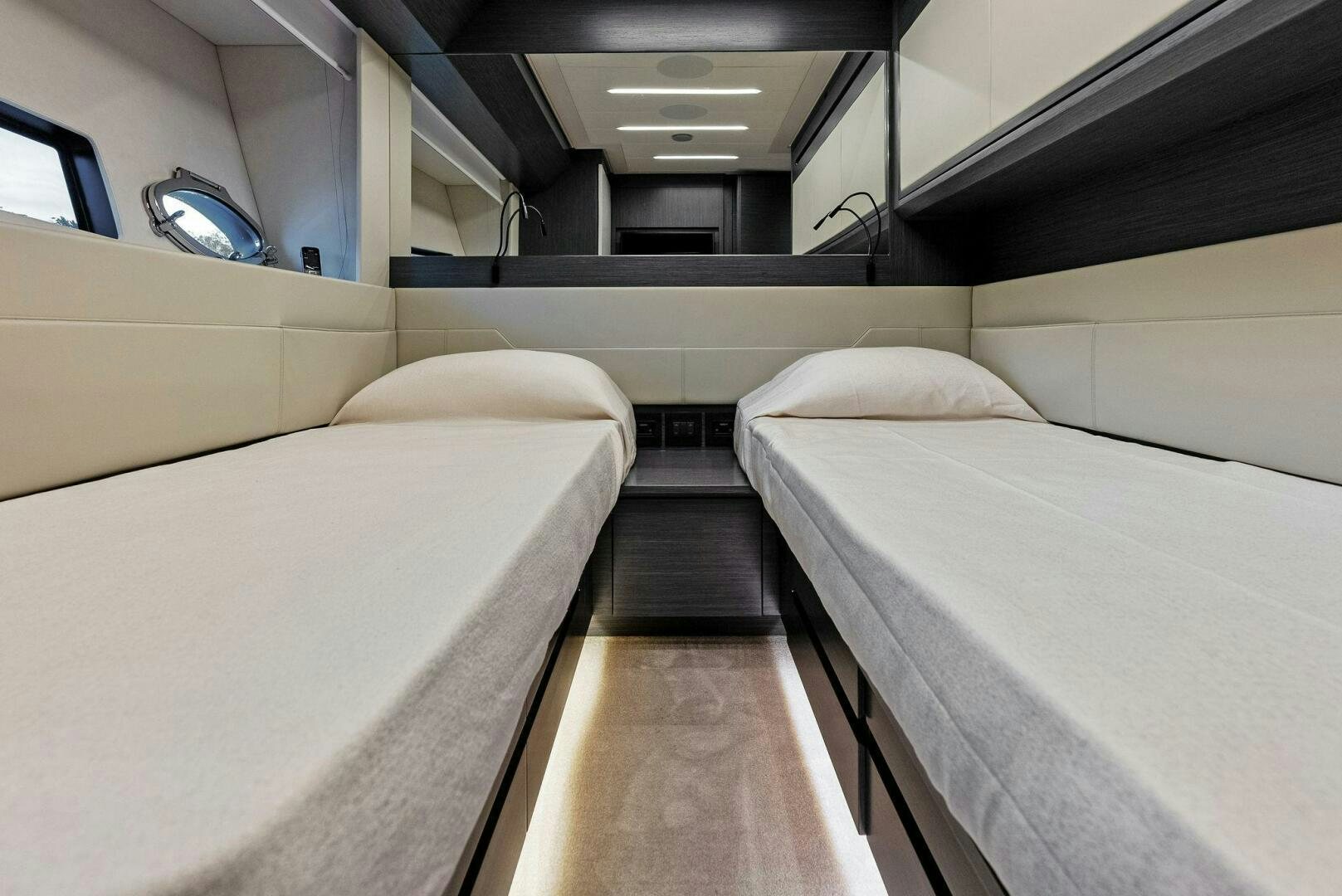 a room with beds and a mirror aboard OUR TRADE Yacht for Sale