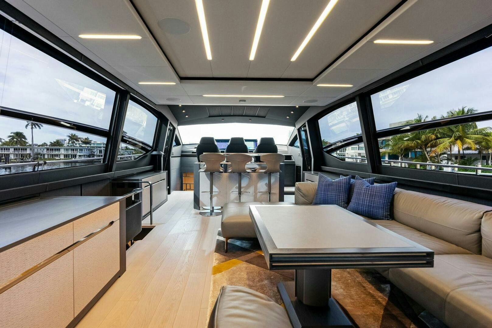 inside of a car with a table and chairs and a bench aboard OUR TRADE Yacht for Sale