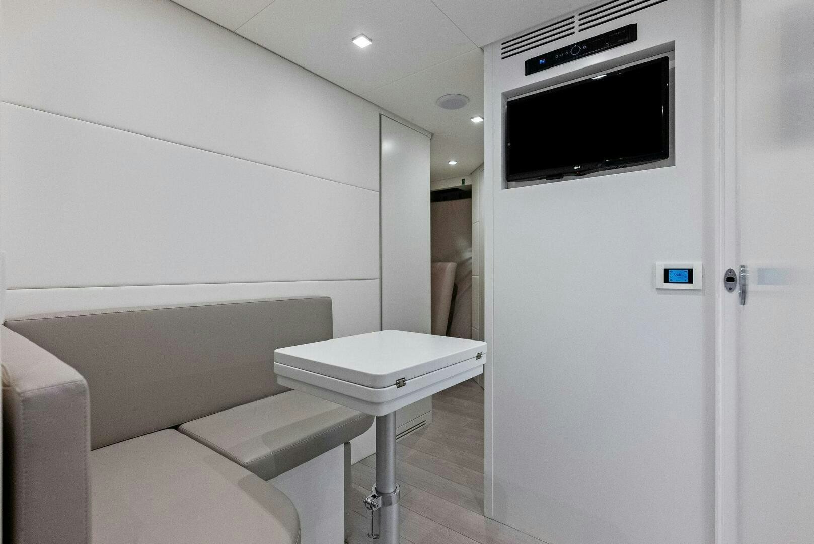 a room with a tv and a table aboard OUR TRADE Yacht for Sale