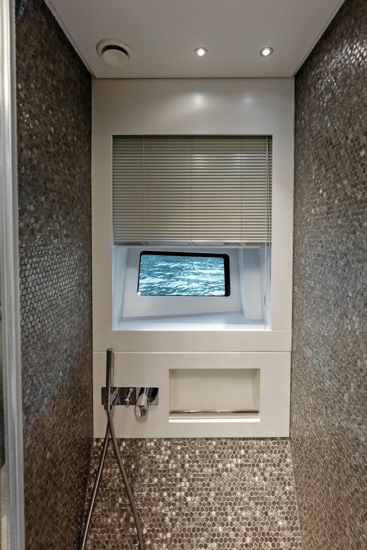 a window with a light on the side aboard OUR TRADE Yacht for Sale