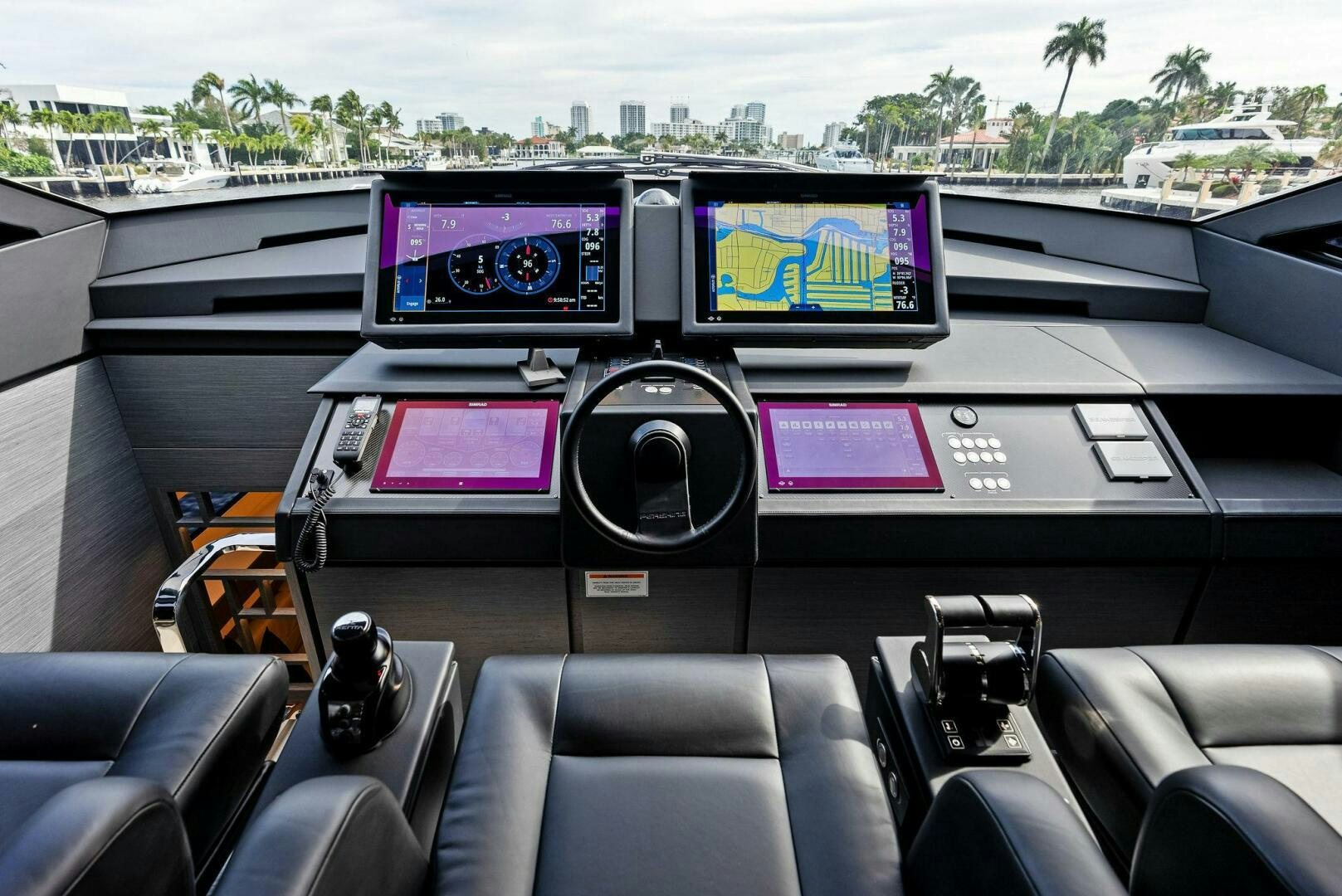 inside of a car with a screen and speakers and a large window aboard OUR TRADE Yacht for Sale