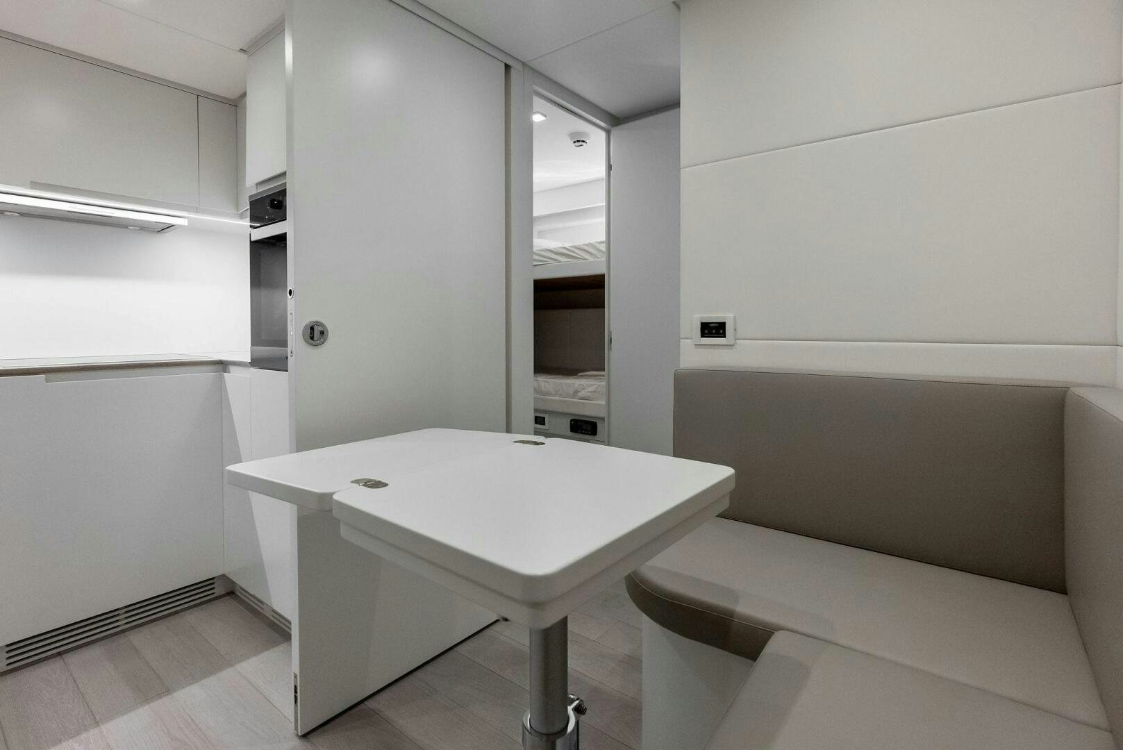 a room with a table and chairs aboard OUR TRADE Yacht for Sale