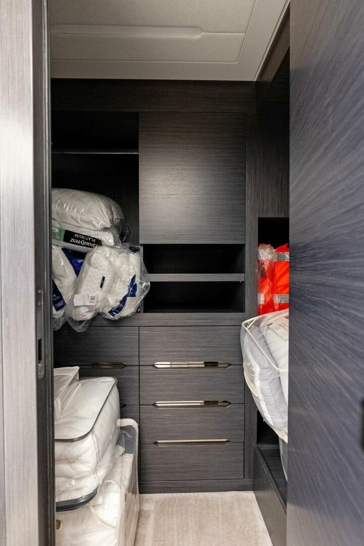 a closet with clothes and a shelf aboard OUR TRADE Yacht for Sale