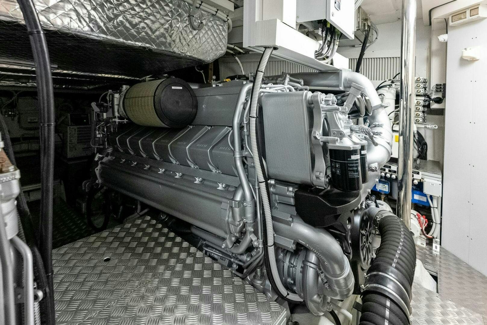 a car with a large engine aboard OUR TRADE Yacht for Sale
