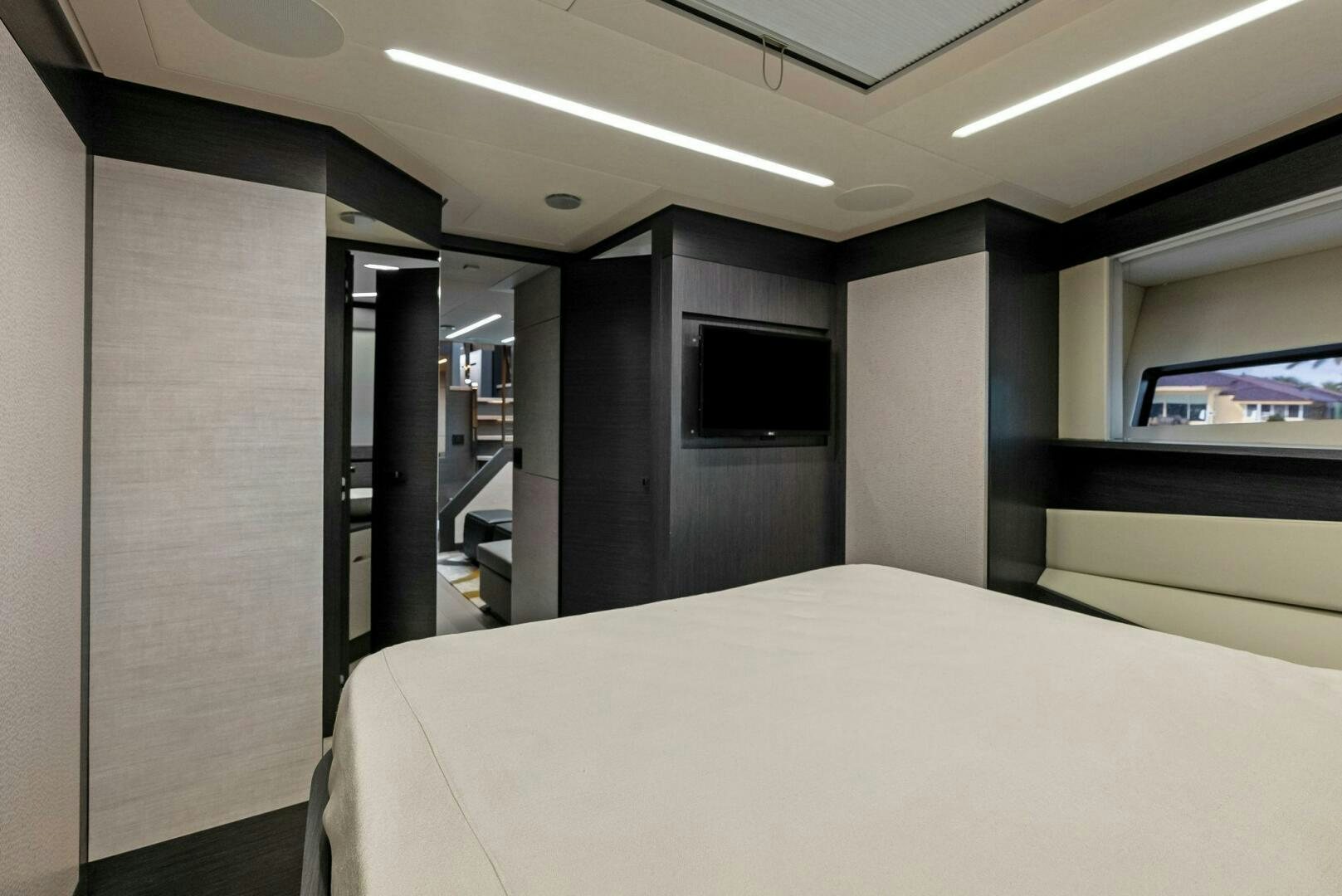 a room with a bed and a television aboard OUR TRADE Yacht for Sale