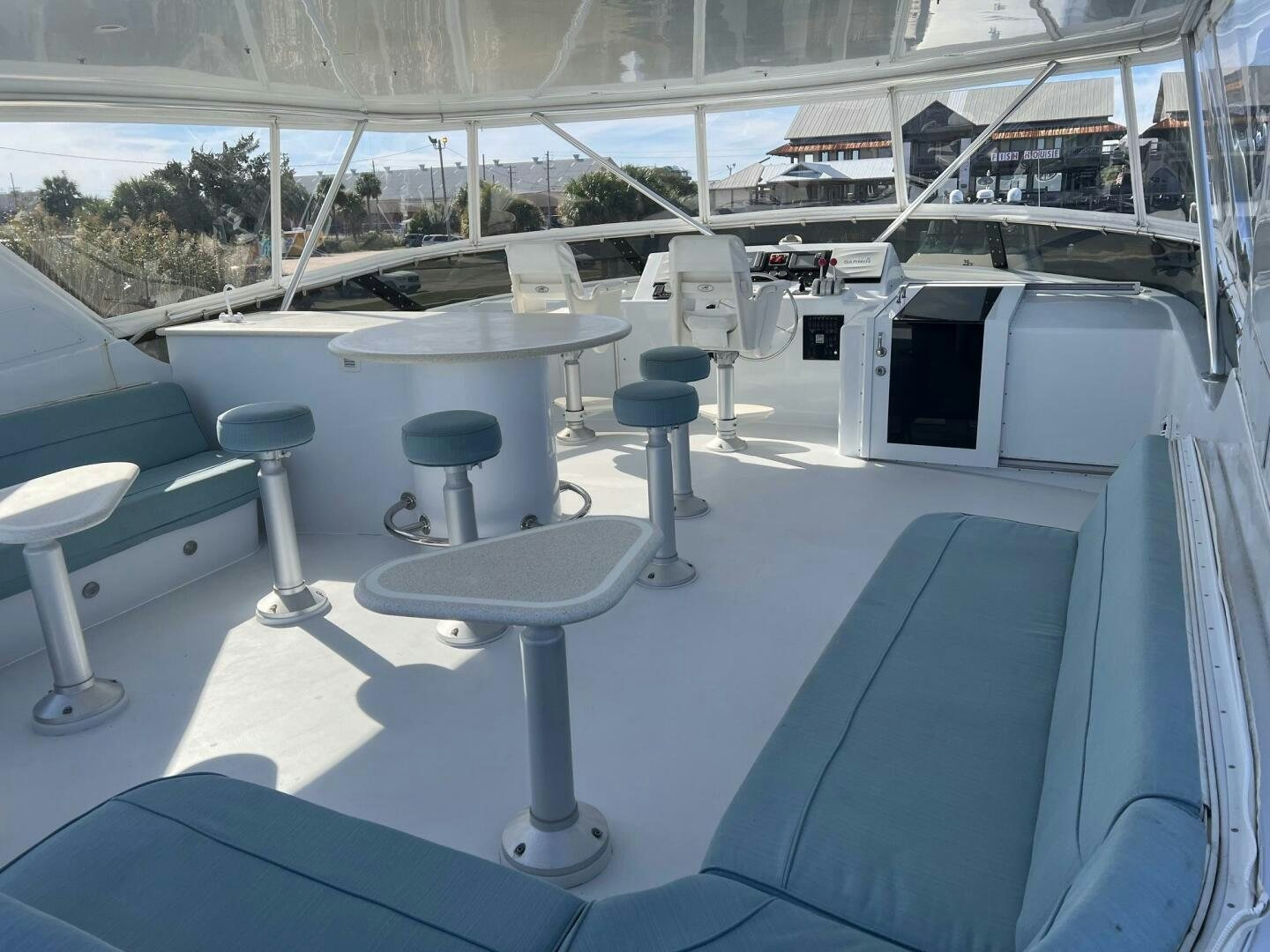 a group of tables and chairs in a room with a large window aboard BAYOU A BUD Yacht for Sale