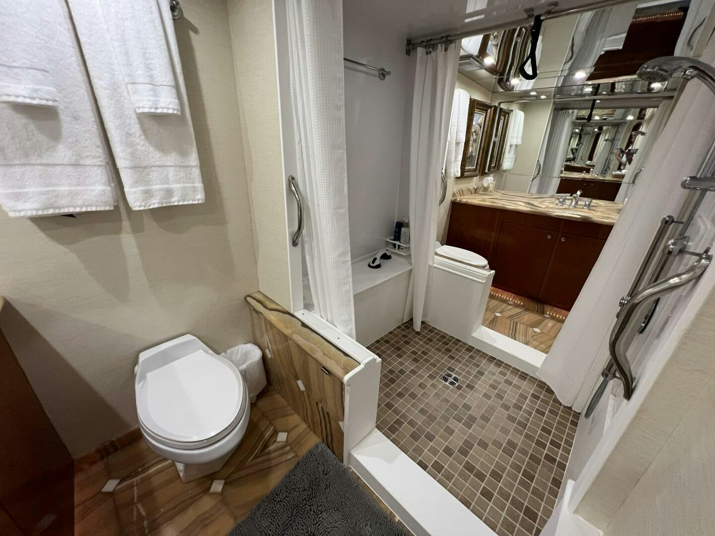 a bathroom with a tub toilet and sink aboard BAYOU A BUD Yacht for Sale