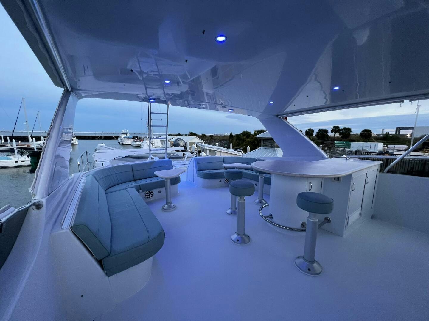 a large white boat with tables and chairs on it aboard BAYOU A BUD Yacht for Sale