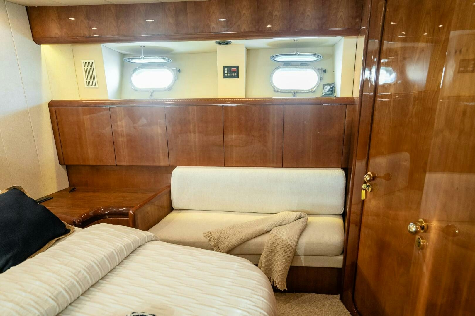 a room with a couch and a wood door aboard PURA VIDA  Yacht for Sale