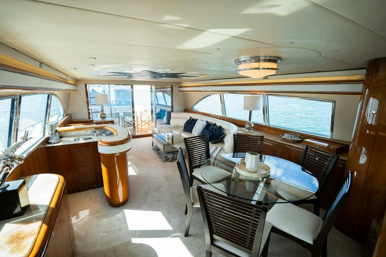 a large dining room with a large window aboard PURA VIDA  Yacht for Sale