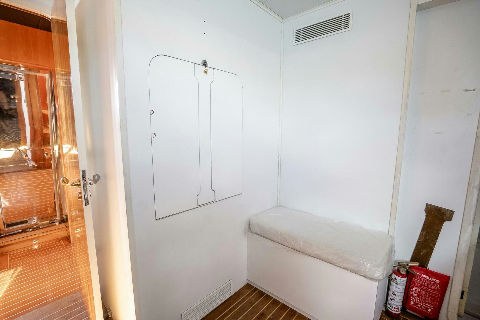 a room with a white door and a white couch aboard PURA VIDA  Yacht for Sale