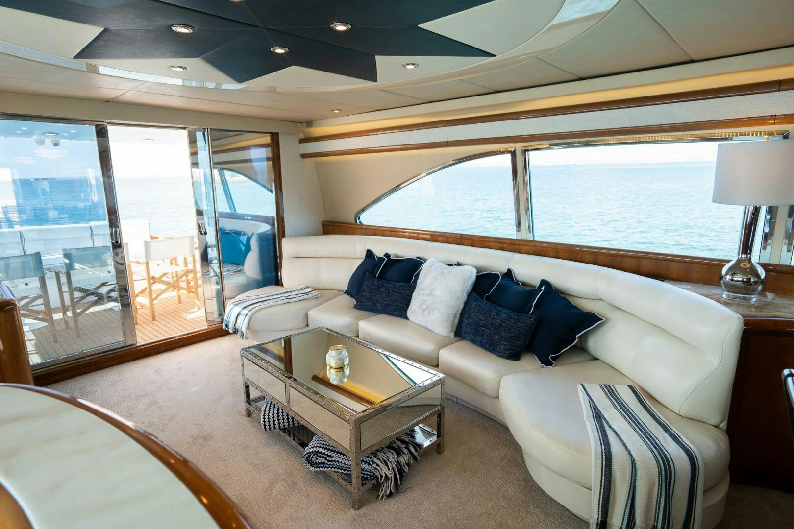 a living room with a large window aboard PURA VIDA  Yacht for Sale