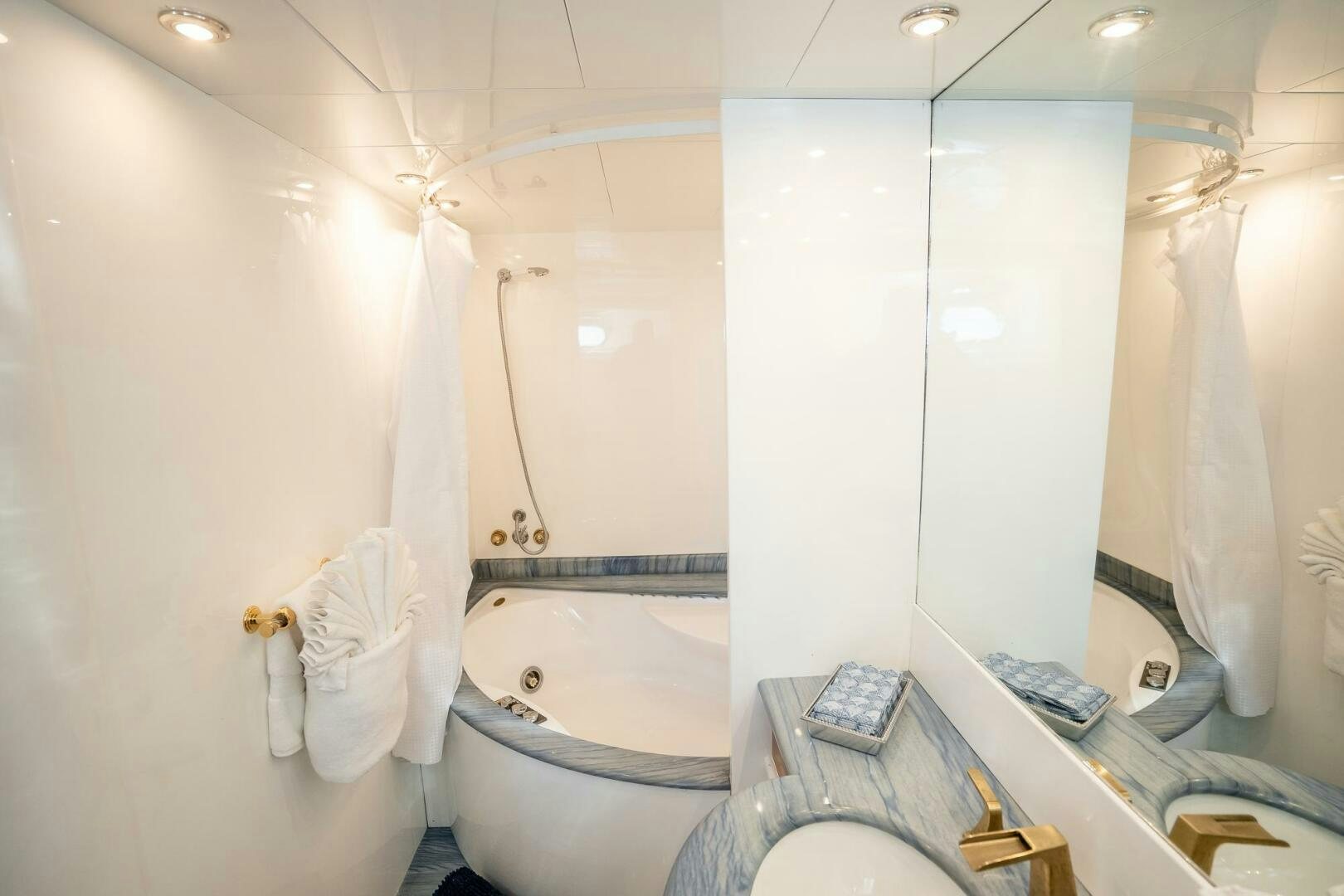 a bathroom with a bathtub and toilet aboard PURA VIDA  Yacht for Sale