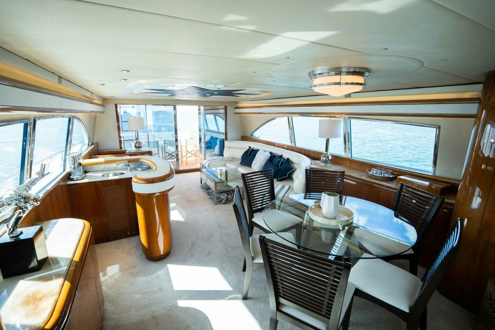 a boat with a table and chairs aboard PURA VIDA  Yacht for Sale