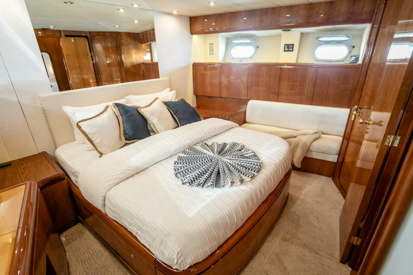 a room with a bed and a wood wall aboard PURA VIDA  Yacht for Sale