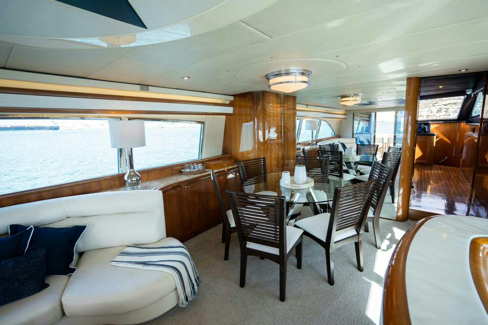 a room with a couch and a table and chairs aboard PURA VIDA  Yacht for Sale