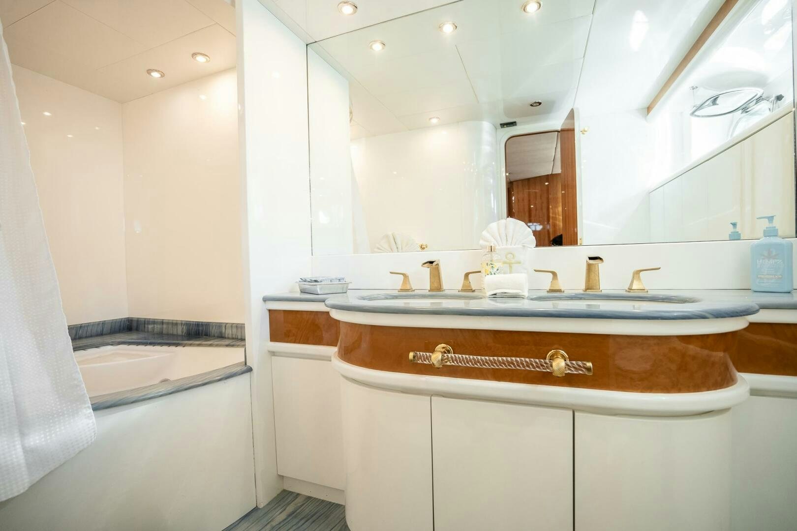 a bathroom with a sink and a bathtub aboard PURA VIDA  Yacht for Sale