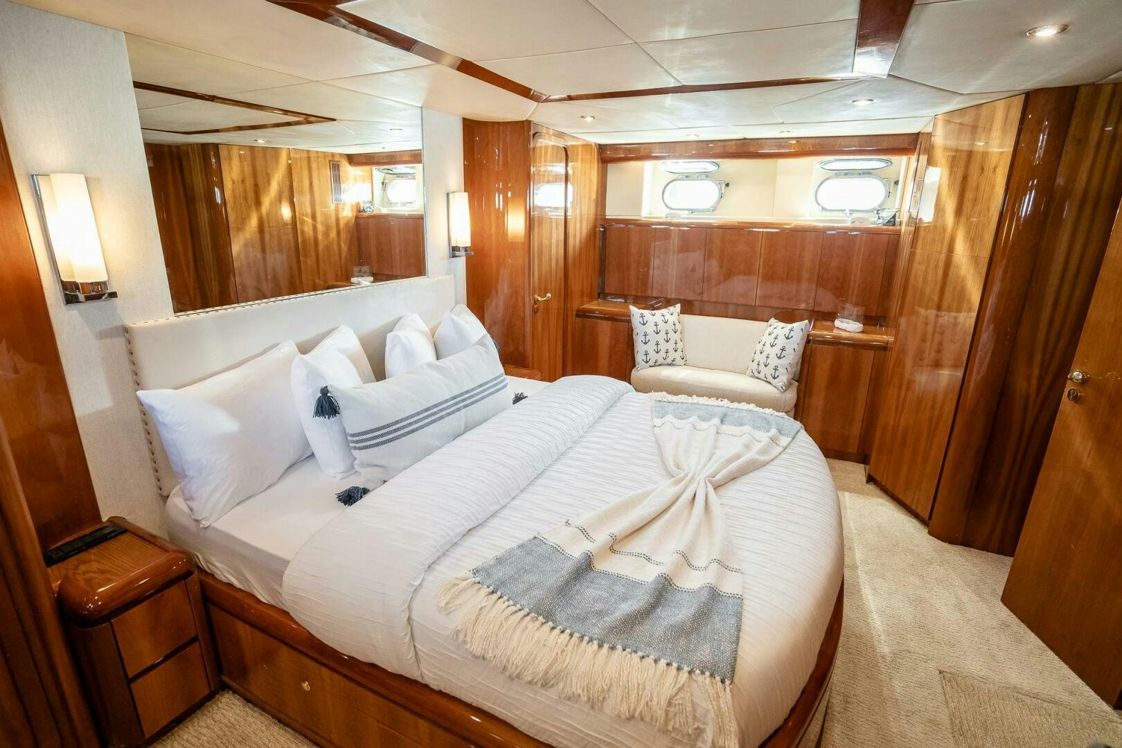 a room with a bed and a chair aboard PURA VIDA  Yacht for Sale