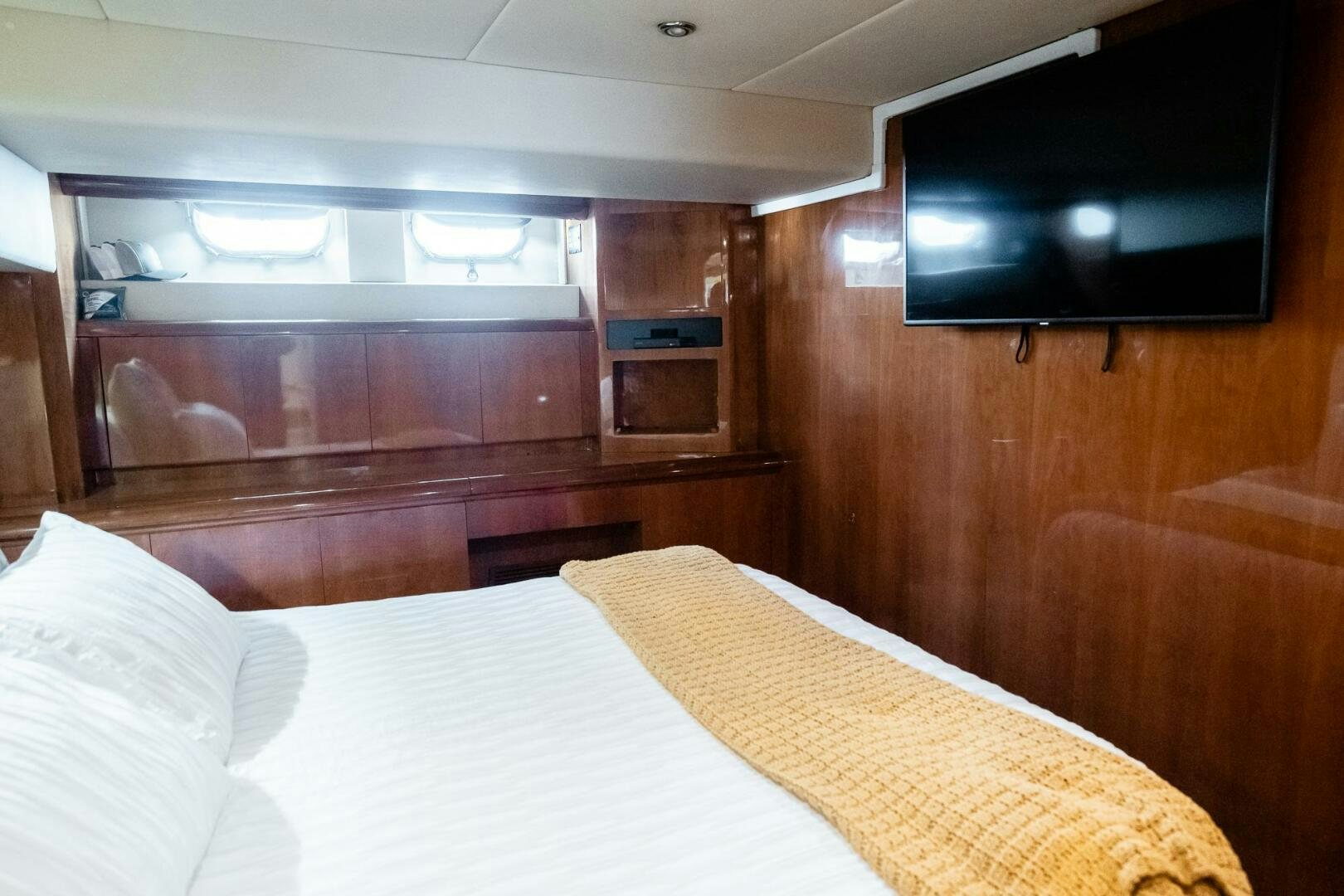a bed in a room aboard PURA VIDA  Yacht for Sale
