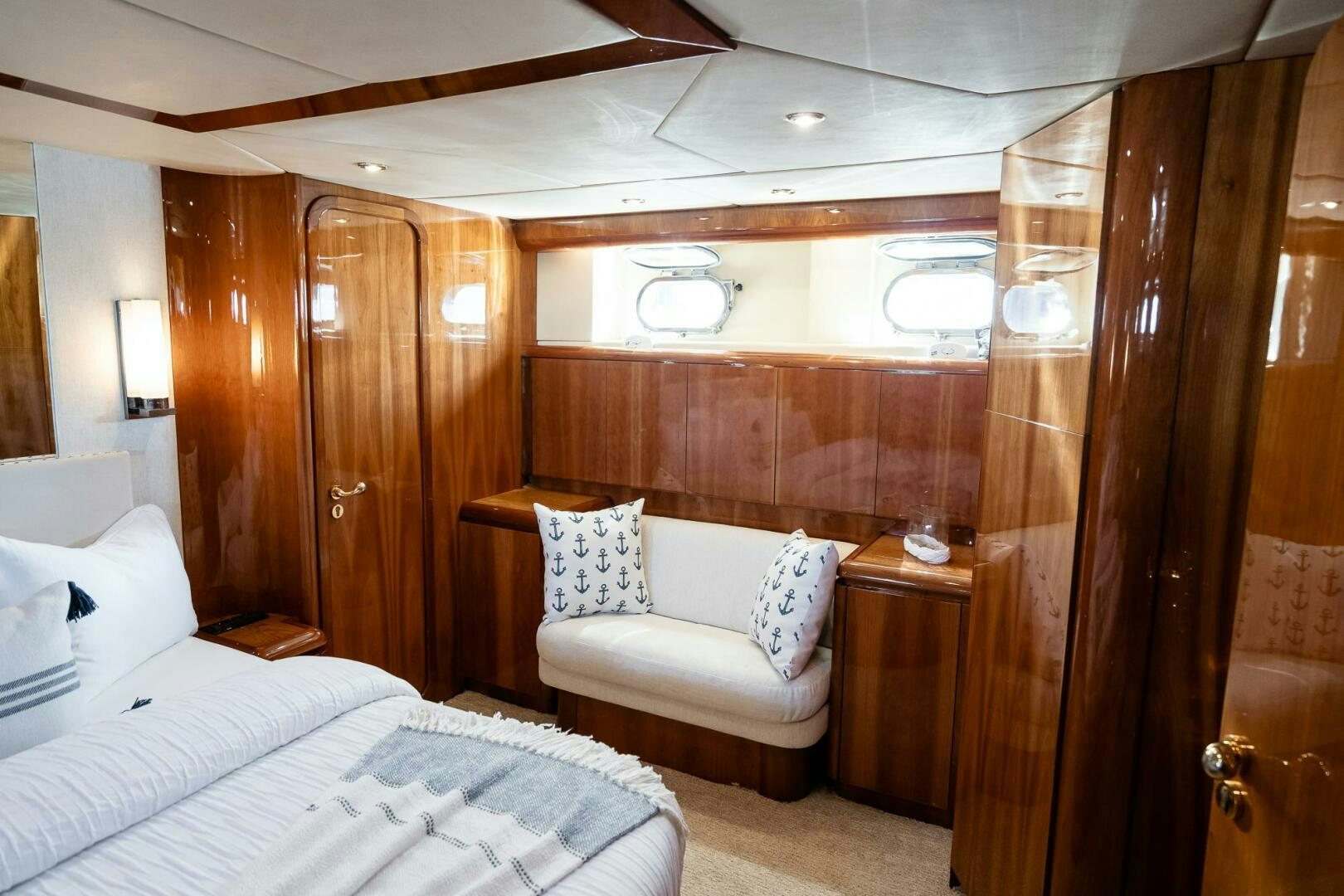a room with a bed and a chair aboard PURA VIDA  Yacht for Sale