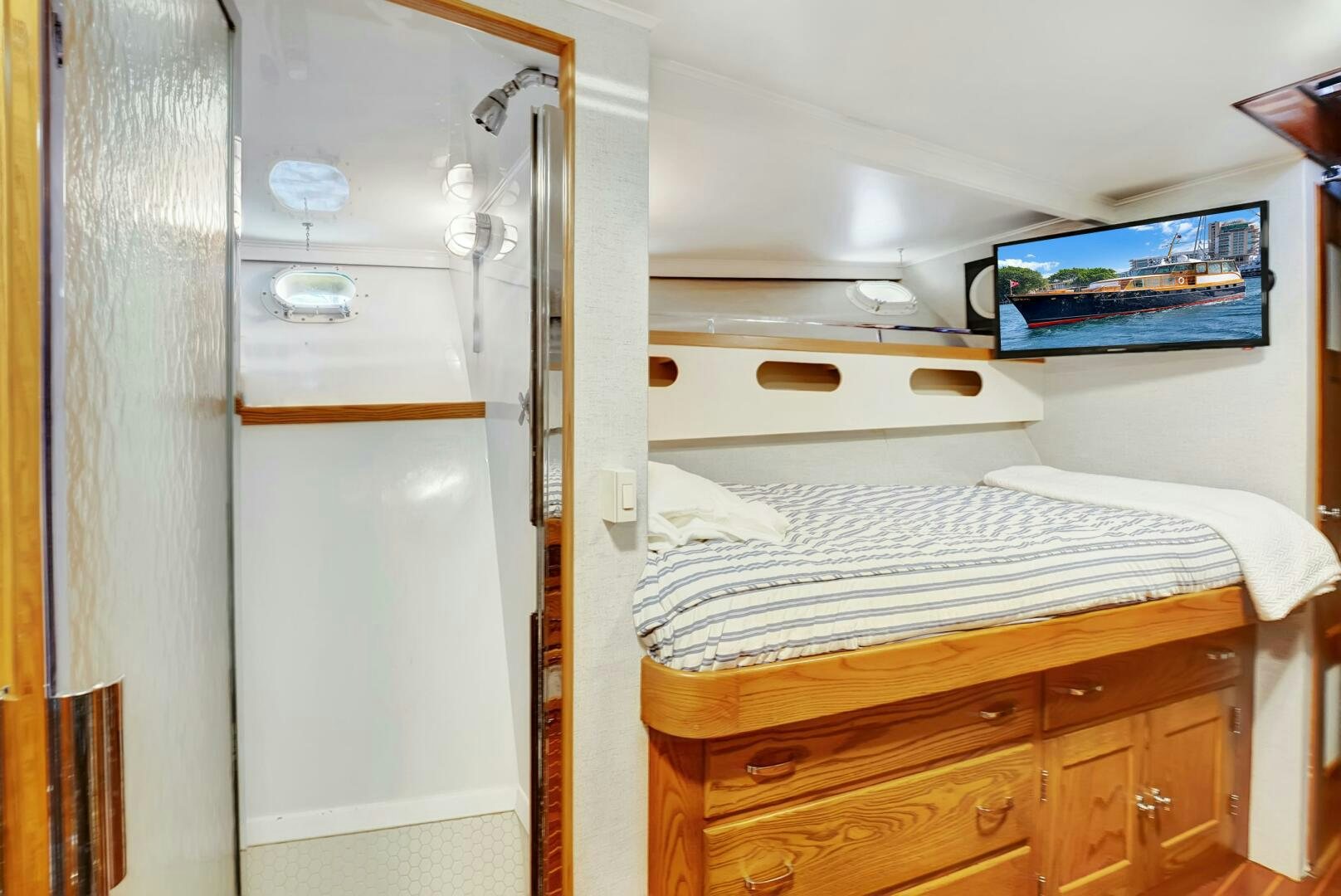 a room with a bed and a dresser aboard EAGLE Yacht for Sale