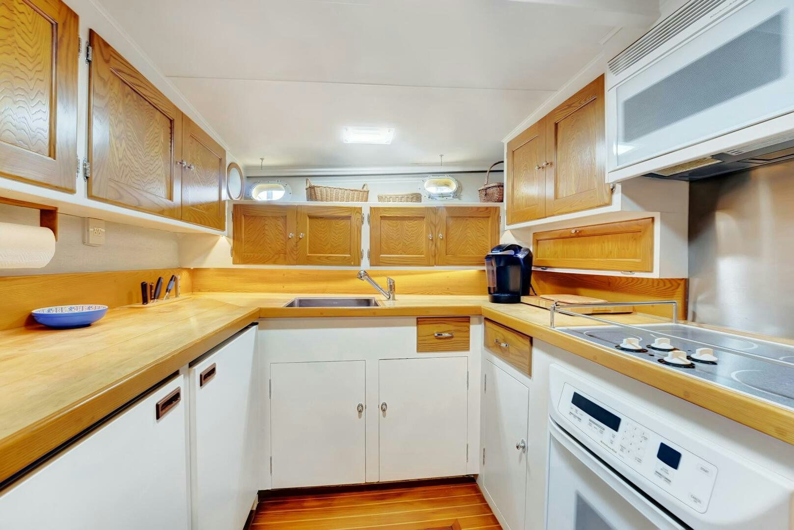a kitchen with white cabinets aboard EAGLE Yacht for Sale