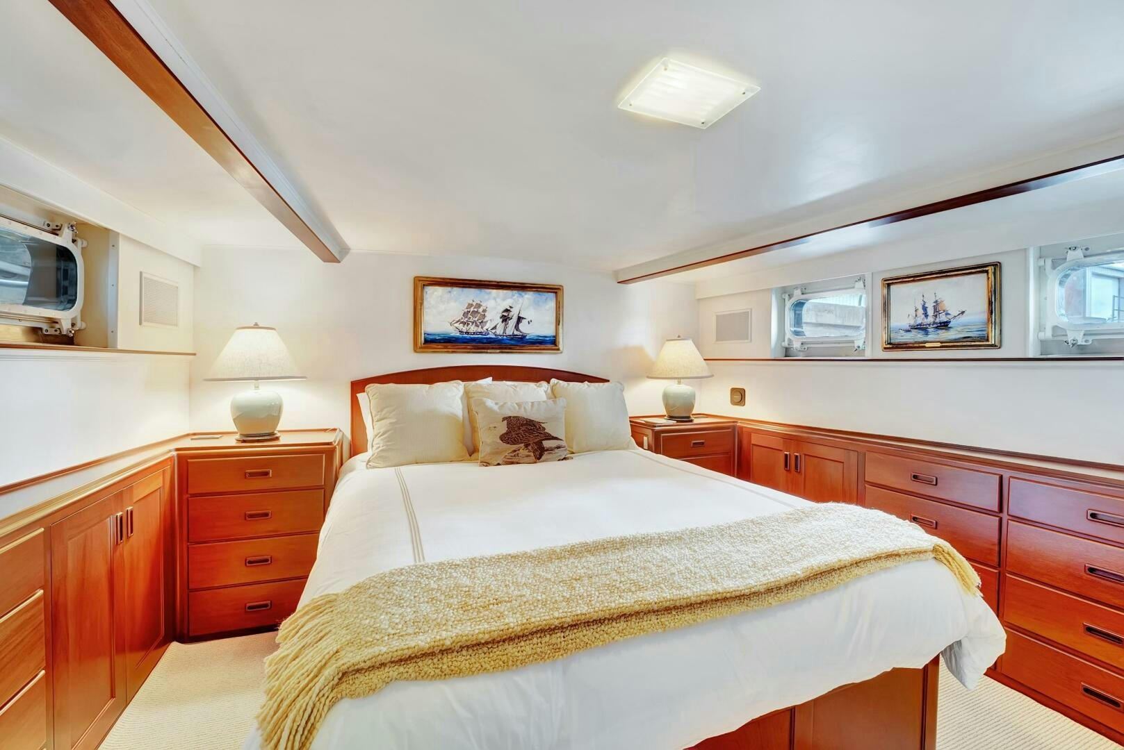 a bedroom with a bed and a dresser aboard EAGLE Yacht for Sale